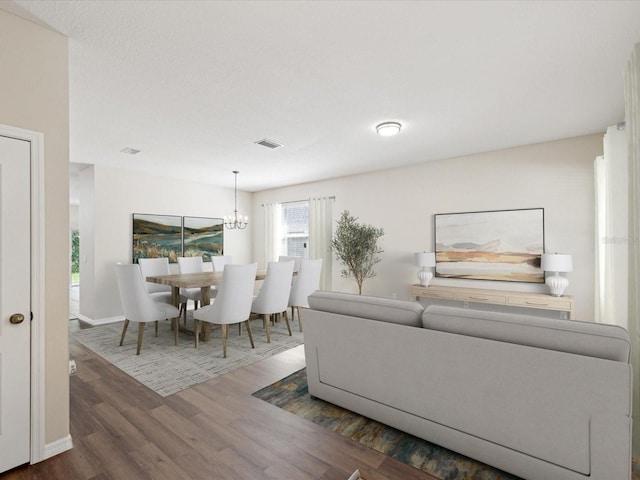 12212 Mcmullen Loop, Riverview, FL 33569 - living area featuring wood finished floors, a chandelier, and baseboards