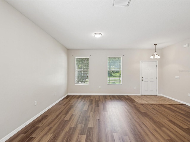 12212 Mcmullen Loop, Riverview, FL 33569 - empty room with a chandelier, wood finished floors, and baseboards