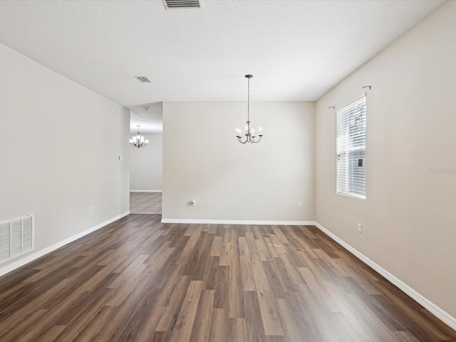 12212 Mcmullen Loop, Riverview, FL 33569 - spare room with a chandelier, dark wood-type flooring, and baseboards