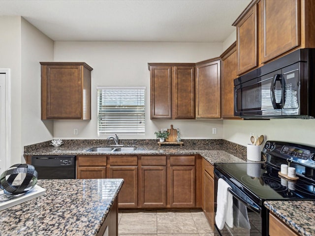12212 Mcmullen Loop, Riverview, FL 33569 - kitchen with black appliances, a sink, and dark stone countertops