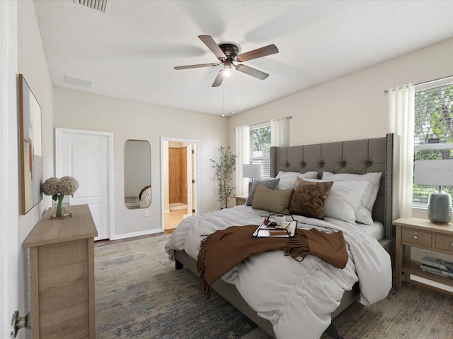 12212 Mcmullen Loop, Riverview, FL 33569 - bedroom featuring connected bathroom, baseboards, and ceiling fan