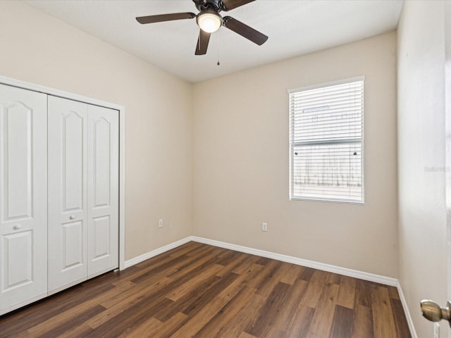 12212 Mcmullen Loop, Riverview, FL 33569 - unfurnished bedroom with dark wood finished floors, baseboards, a closet, and a ceiling fan