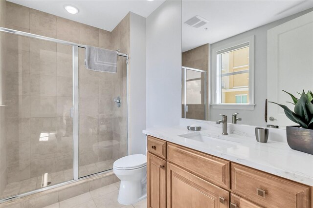 140 Riviera Dunes Way Unit 1203, Palmetto, FL 34221 - bathroom with toilet, a stall shower, tile patterned flooring, and vanity