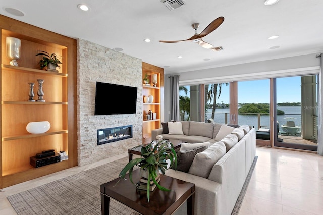 443 18th Ave, Indian Rocks Beach, FL 33785 - living room with built in shelves, light tile patterned floors, a stone fireplace, a ceiling fan, and recessed lighting