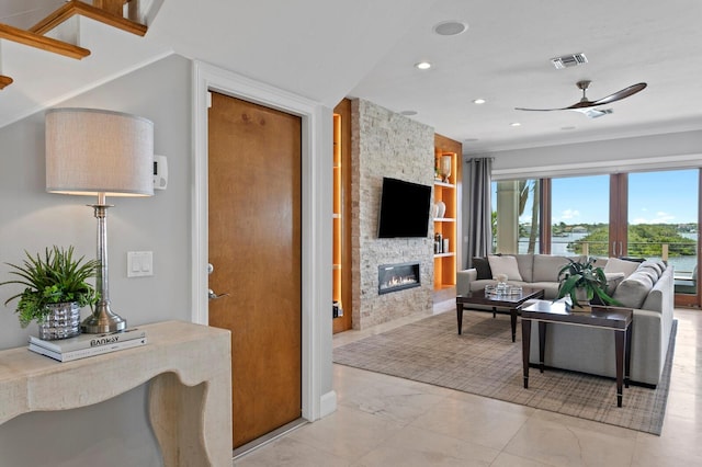 443 18th Ave, Indian Rocks Beach, FL 33785 - living room featuring built in features, a stone fireplace, a ceiling fan, recessed lighting, and light marble finish floors