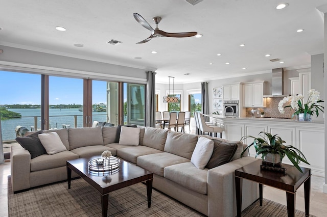 443 18th Ave, Indian Rocks Beach, FL 33785 - living room featuring a ceiling fan, ornamental molding, recessed lighting, and a water view