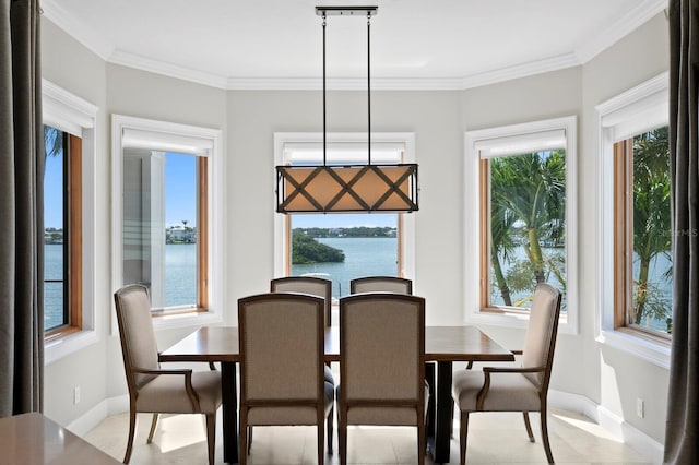 443 18th Ave, Indian Rocks Beach, FL 33785 - dining room featuring a water view, healthy amount of natural light, baseboards, and ornamental molding