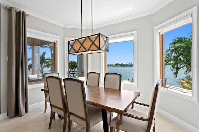 443 18th Ave, Indian Rocks Beach, FL 33785 - dining area with healthy amount of natural light, baseboards, a water view, crown molding, and light tile patterned floors