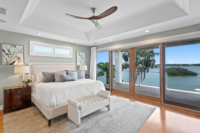 443 18th Ave, Indian Rocks Beach, FL 33785 - bedroom with a tray ceiling, light wood-style flooring, access to exterior, a water view, and recessed lighting