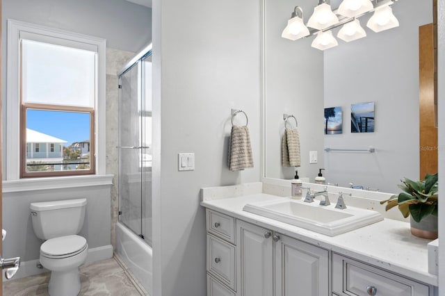 443 18th Ave, Indian Rocks Beach, FL 33785 - bathroom featuring vanity, toilet, a chandelier, baseboards, and combined bath / shower with glass door