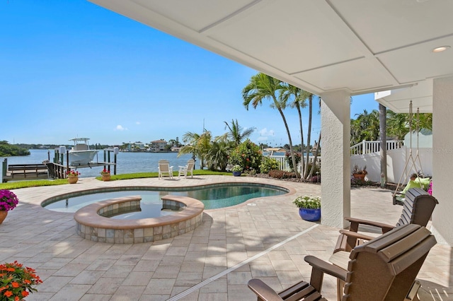 443 18th Ave, Indian Rocks Beach, FL 33785 - view of pool featuring boat lift, a patio area, a boat dock, a water view, and a pool with connected hot tub