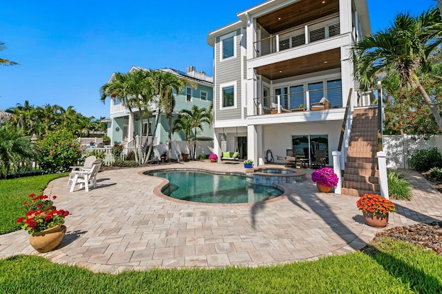 443 18th Ave, Indian Rocks Beach, FL 33785 - rear view of property with a balcony, a patio, a pool with connected hot tub, stairway, and stucco siding