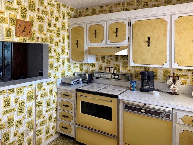 7910 Sun Island Dr S Unit 404, South Pasadena, FL 33707 - kitchen with electric range, under cabinet range hood, dishwasher, wallpapered walls, and light countertops