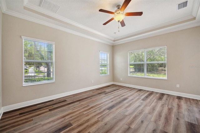 5117 Longspur Ct, Lithia, FL 33547 - spare room with crown molding, wood finished floors, baseboards, ceiling fan, and a raised ceiling
