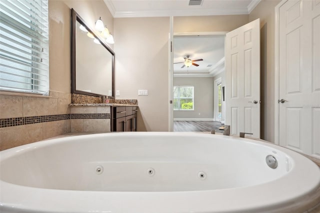 5117 Longspur Ct, Lithia, FL 33547 - full bath featuring ornamental molding, ceiling fan, a tub with jets, and vanity
