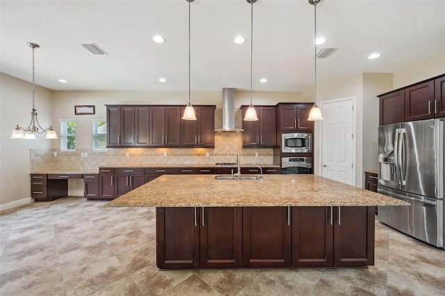 5117 Longspur Ct, Lithia, FL 33547 - kitchen with appliances with stainless steel finishes, wall chimney exhaust hood, a sink, decorative backsplash, and recessed lighting