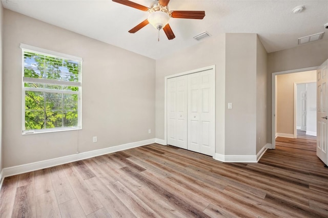 5117 Longspur Ct, Lithia, FL 33547 - unfurnished bedroom featuring baseboards, wood finished floors, and a closet