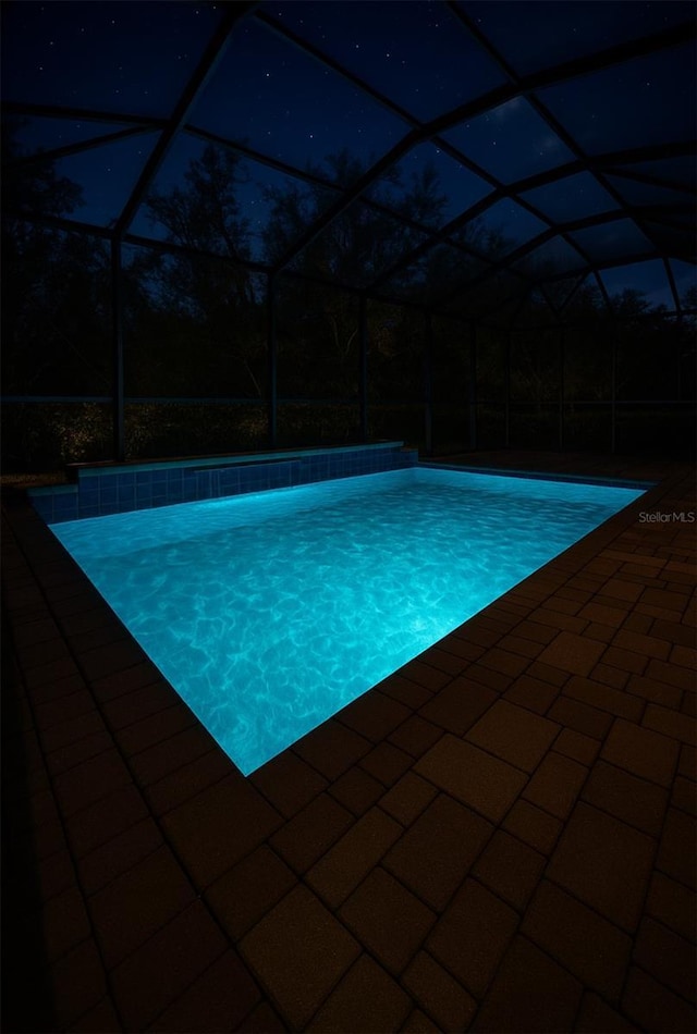 5117 Longspur Ct, Lithia, FL 33547 - outdoor pool with a patio and glass enclosure