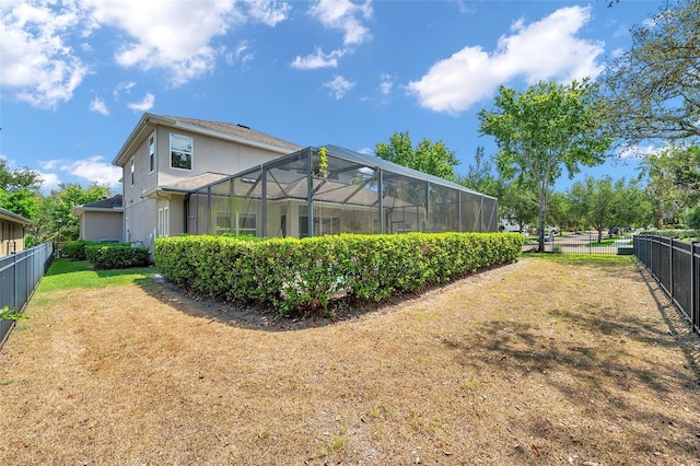 5117 Longspur Ct, Lithia, FL 33547 - back of house featuring stucco siding and a lanai