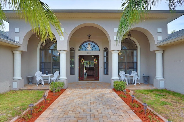 entrance to property with stucco siding