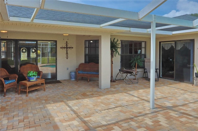 view of patio / terrace featuring a lanai and a jacuzzi