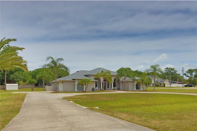 view of front of home featuring concrete driveway and stucco siding