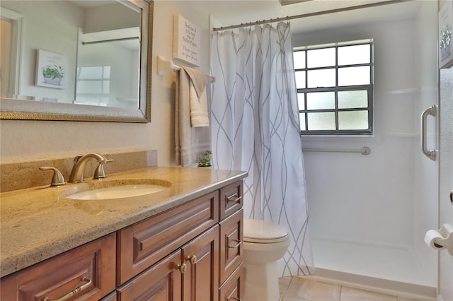 bathroom featuring curtained shower, toilet, vanity, and tile patterned floors