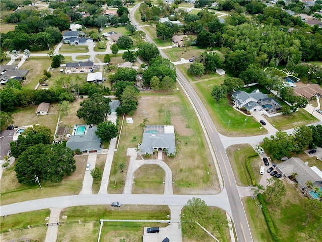 aerial view of property and surrounding area with nearby suburban area