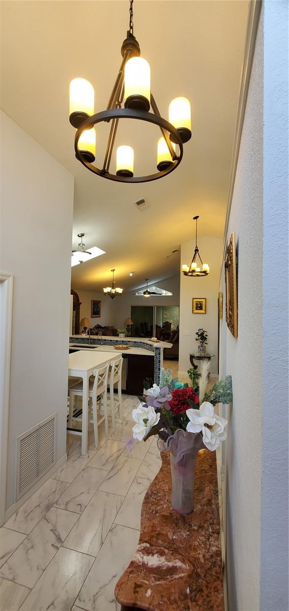 8207 Volusia Pl, Tampa, FL 33637 - dining room featuring a chandelier and light marble finish flooring