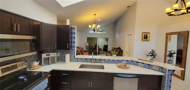 8207 Volusia Pl, Tampa, FL 33637 - kitchen featuring a chandelier, appliances with stainless steel finishes, a sink, a peninsula, and decorative backsplash