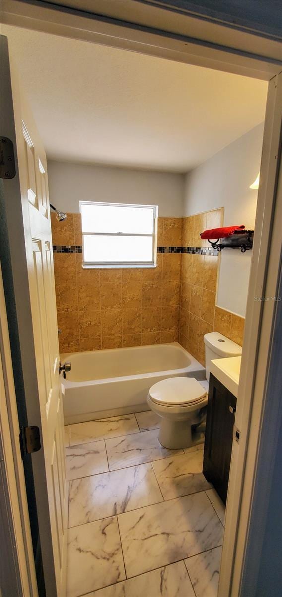 8207 Volusia Pl, Tampa, FL 33637 - full bathroom with vanity, toilet, marble finish floors, and  shower combination