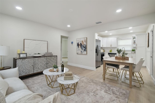 1404 E Curtis St, Tampa, FL 33603 - living room with light wood-type flooring, recessed lighting, and baseboards