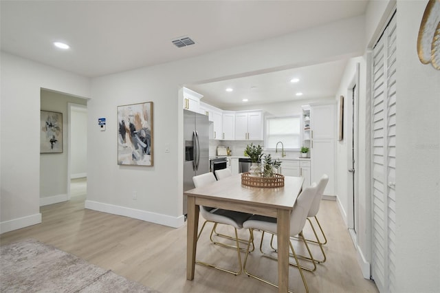 1404 E Curtis St, Tampa, FL 33603 - dining space featuring recessed lighting, light wood-type flooring, and baseboards