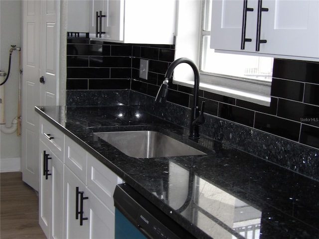 2699 Seville Blvd Unit 802, Clearwater, FL 33764 - kitchen featuring a sink, white cabinetry, backsplash, and dark stone countertops
