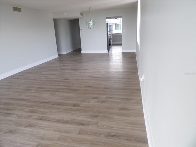 2699 Seville Blvd Unit 802, Clearwater, FL 33764 - unfurnished room with baseboards and wood finished floors