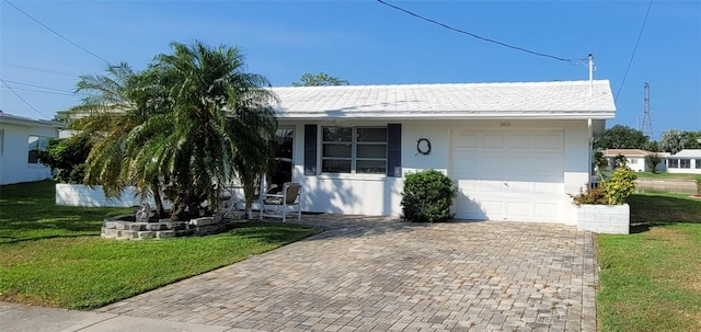 10040 38th Way N, Pinellas Park, FL 33782 - ranch-style home featuring a front yard, a garage, decorative driveway, and stucco siding