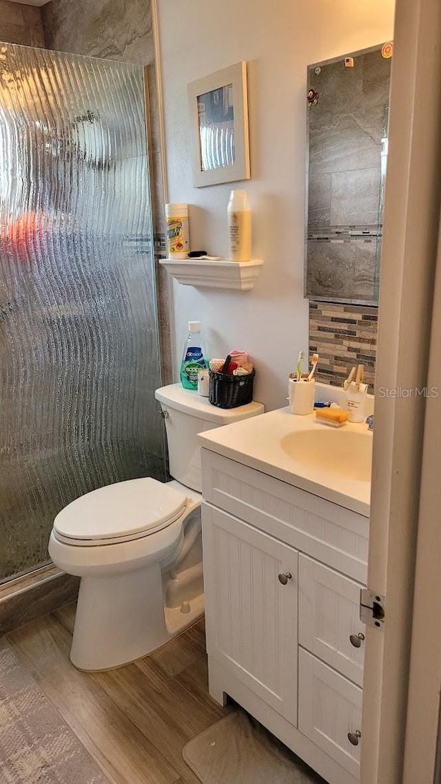 10040 38th Way N, Pinellas Park, FL 33782 - full bath with wood finished floors, toilet, a stall shower, and vanity