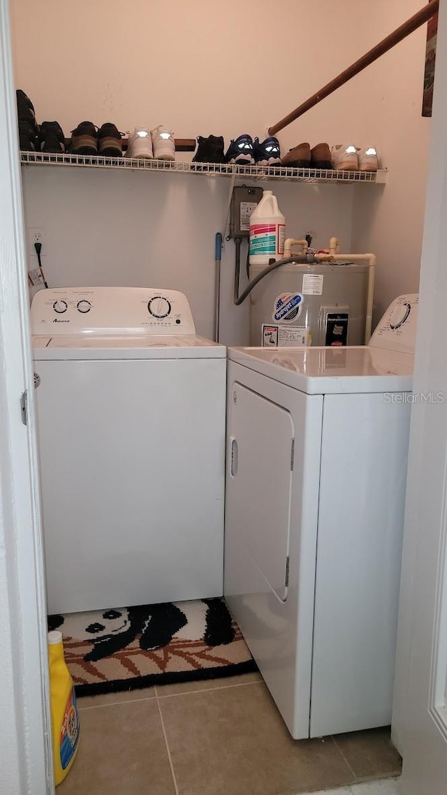 10040 38th Way N, Pinellas Park, FL 33782 - washroom with washer and clothes dryer, light tile patterned flooring, and electric water heater