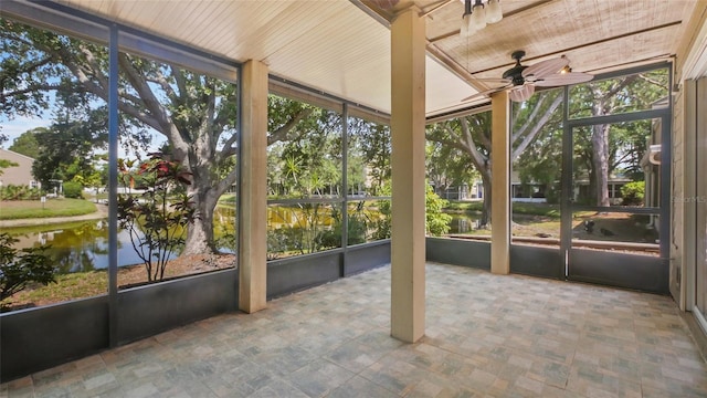 9050 Lake Place Ln, Tampa, FL 33634 - unfurnished sunroom with a ceiling fan, a water view, and plenty of natural light