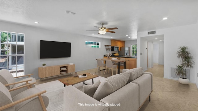 9050 Lake Place Ln, Tampa, FL 33634 - living room with recessed lighting, healthy amount of natural light, ceiling fan, and light tile patterned flooring