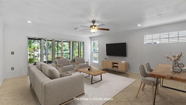 9050 Lake Place Ln, Tampa, FL 33634 - living area with a ceiling fan, light tile patterned floors, recessed lighting, and baseboards