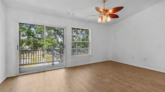 9050 Lake Place Ln, Tampa, FL 33634 - spare room featuring wood finished floors, baseboards, and a ceiling fan