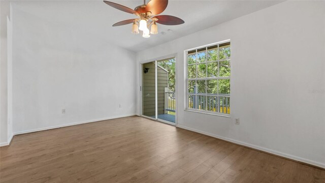 9050 Lake Place Ln, Tampa, FL 33634 - unfurnished room featuring a ceiling fan, wood finished floors, and baseboards