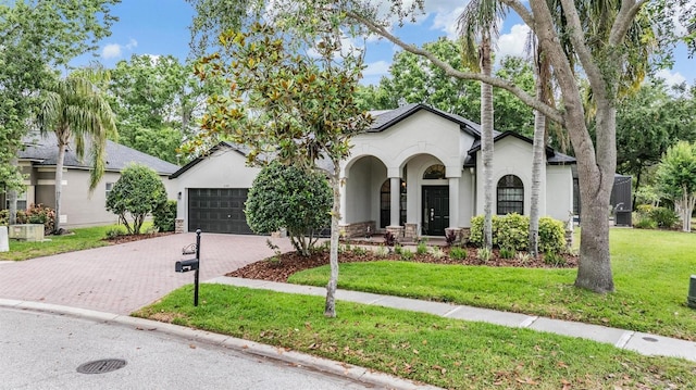 5109 Hartwell Loop, Land O Lakes, FL 34638 - view of front of home with stucco siding, decorative driveway, an attached garage, and a front yard
