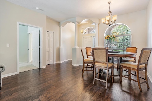 5109 Hartwell Loop, Land O Lakes, FL 34638 - dining area with ornate columns, a chandelier, dark wood-type flooring, baseboards, and arched walkways