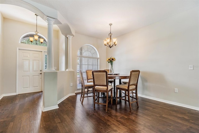 5109 Hartwell Loop, Land O Lakes, FL 34638 - dining room featuring a chandelier, hardwood / wood-style floors, ornate columns, arched walkways, and baseboards
