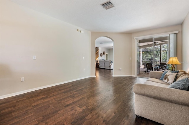 5109 Hartwell Loop, Land O Lakes, FL 34638 - living room featuring arched walkways, dark wood-type flooring, baseboards, and ceiling fan