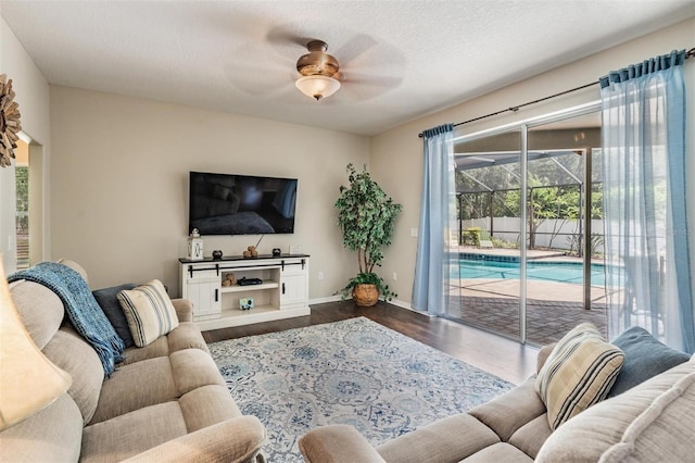 5109 Hartwell Loop, Land O Lakes, FL 34638 - living area featuring dark wood-type flooring, ceiling fan, and baseboards