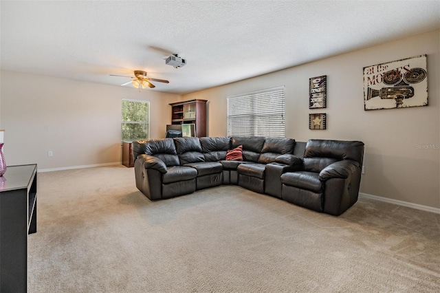 5109 Hartwell Loop, Land O Lakes, FL 34638 - living area featuring light carpet, ceiling fan, and baseboards