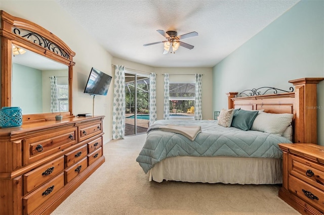5109 Hartwell Loop, Land O Lakes, FL 34638 - bedroom with light colored carpet, access to exterior, a ceiling fan, and a textured ceiling